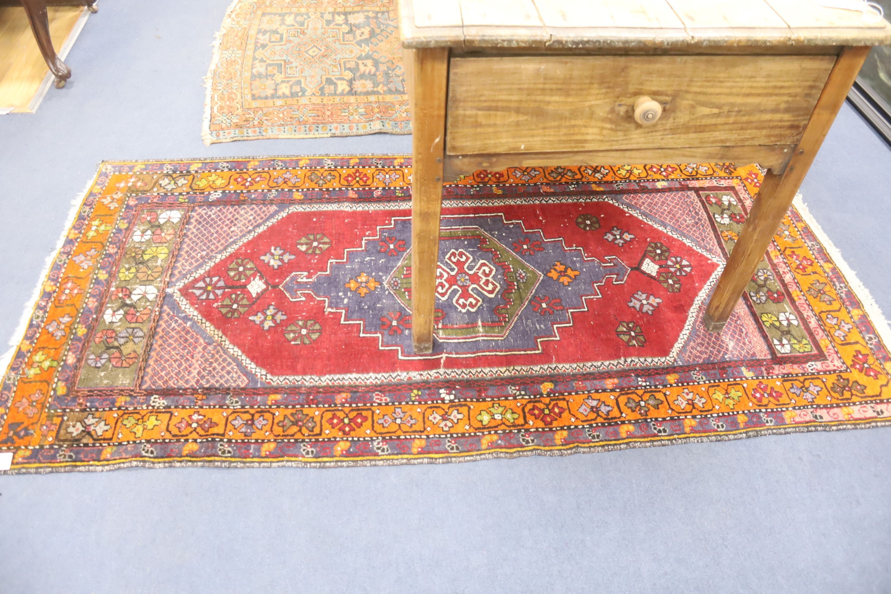 A Caucasian polychrome geometric rug, 200 x 100cm